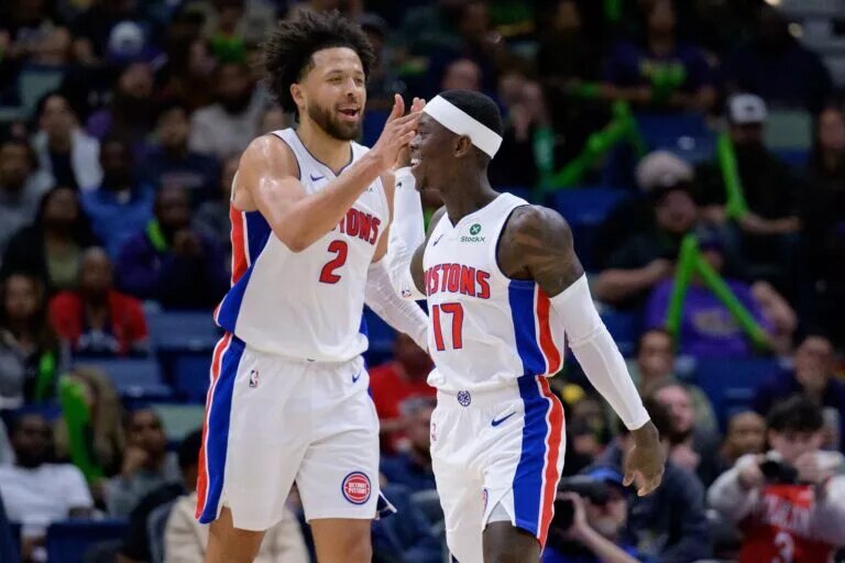 Detroit Pistons guard Cade Cunningham (2) celebrates a basket with guard Dennis Schroder (17) against the New Orleans Pelicans during the second half at Smoothie King Center.