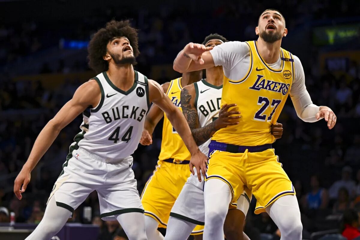 Mar 20, 2025; Los Angeles, California, USA; Los Angeles Lakers center Alex Len (27) attempts to gain possession against Milwaukee Bucks guard Andre Jackson Jr. (44) during the second half at Crypto.com Arena. Mandatory Credit: Jonathan Hui-Imagn Images