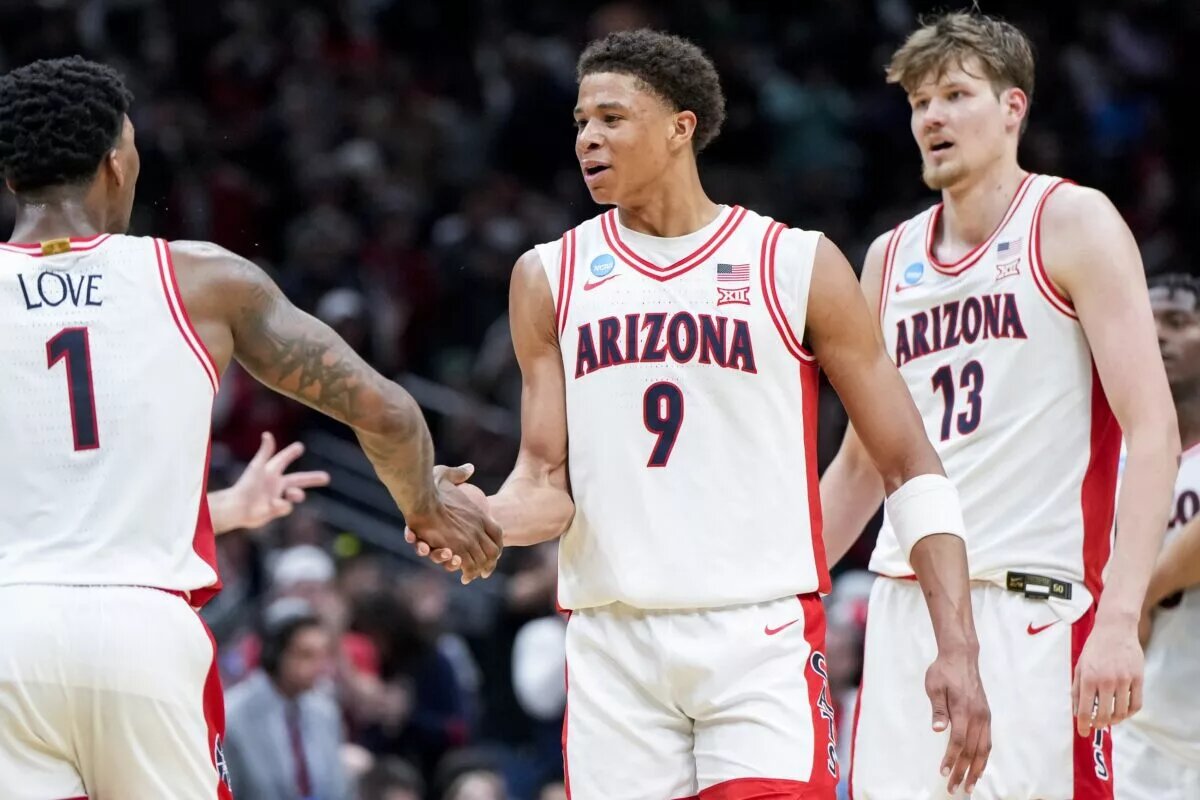 Mar 23, 2025; Seattle, WA, USA; Arizona Wildcats guard Caleb Love (1) high-fives forward Carter Bryant (9) during a stop in play against the Oregon Ducks in the second half at Climate Pledge Arena. Mandatory Credit: Stephen Brashear-Imagn Images