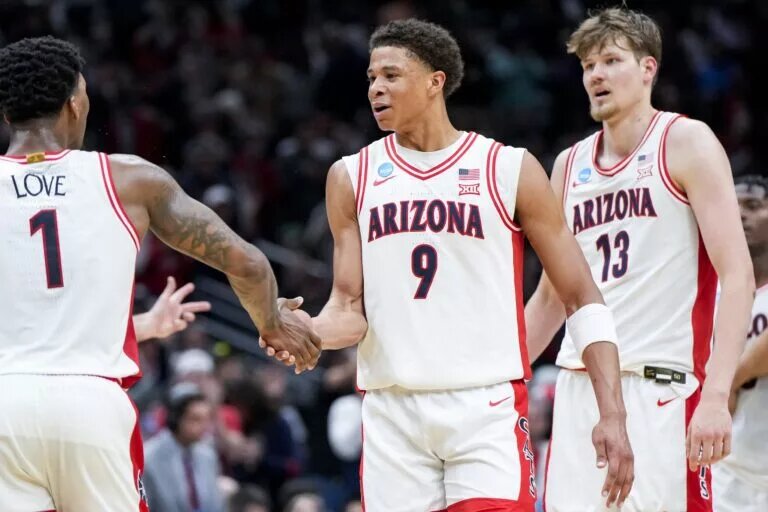 Mar 23, 2025; Seattle, WA, USA; Arizona Wildcats guard Caleb Love (1) high-fives forward Carter Bryant (9) during a stop in play against the Oregon Ducks in the second half at Climate Pledge Arena. Mandatory Credit: Stephen Brashear-Imagn Images