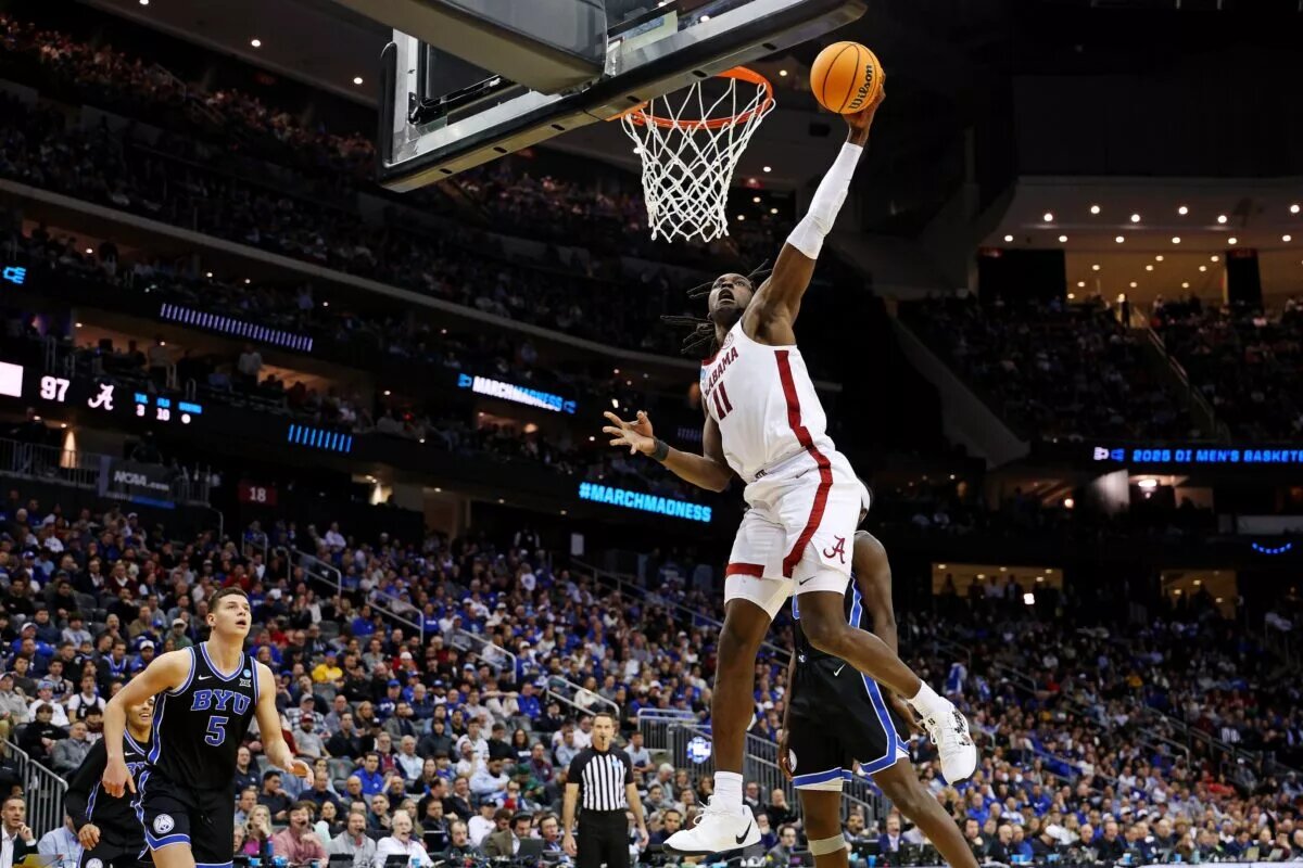 Mar 27, 2025; Newark, NJ, USA; Alabama Crimson Tide center Clifford Omoruyi (11) dunks the ball against Brigham Young Cougars forward Mawot Mag (0) during the second half during an East Regional semifinal of the 2025 NCAA tournament at Prudential Center. Mandatory Credit: Vincent Carchietta-Imagn Images