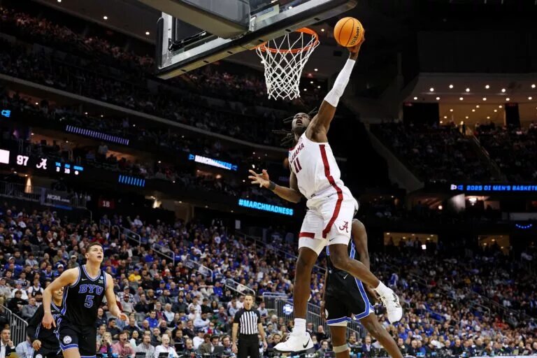 Mar 27, 2025; Newark, NJ, USA; Alabama Crimson Tide center Clifford Omoruyi (11) dunks the ball against Brigham Young Cougars forward Mawot Mag (0) during the second half during an East Regional semifinal of the 2025 NCAA tournament at Prudential Center. Mandatory Credit: Vincent Carchietta-Imagn Images