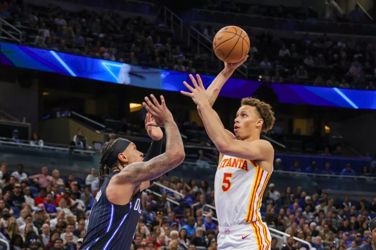 Apr 8, 2025; Orlando, Florida, USA; Atlanta Hawks guard Dyson Daniels (5) shoots the ball over Orlando Magic forward Paolo Banchero (5) during the second quarter at Kia Center. Mandatory Credit: Mike Watters-Imagn Images