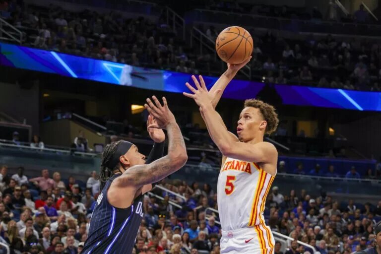 Apr 8, 2025; Orlando, Florida, USA; Atlanta Hawks guard Dyson Daniels (5) shoots the ball over Orlando Magic forward Paolo Banchero (5) during the second quarter at Kia Center. Mandatory Credit: Mike Watters-Imagn Images
