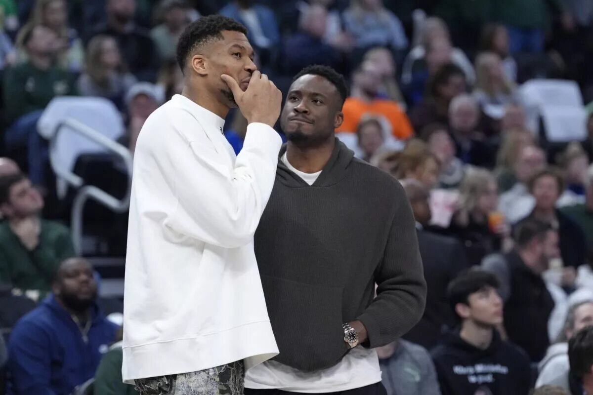 Apr 13, 2025; Milwaukee, Wisconsin, USA; Milwaukee Bucks forward Giannis Antetokounmpo (34) and his brother Milwaukee Bucks forward Thanasis Antetokounmpo talks during a time out against the Detroit Pistons in the second half at Fiserv Forum. Mandatory Credit: Michael McLoone-Imagn Images