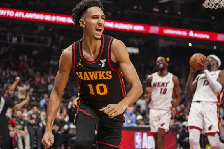 Atlanta Hawks forward Zaccharie Risacher (10) reacts after scoring a basket against the Miami Heat during the first half at State Farm Arena.
