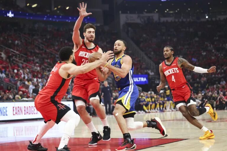 Houston Rockets guard Fred VanVleet (5) and center Alperen Sengun (28) defend against Golden State Warriors guard Stephen Curry (30) during the first quarter during game two of the first round for the 2024 NBA Playoffs at Toyota Center.