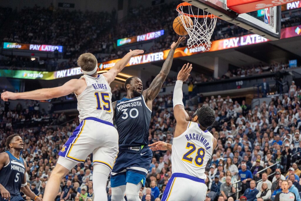 Apr 27, 2025; Minneapolis, Minnesota, USA; Minnesota Timberwolves forward Julius Randle (30) shoots as Los Angeles Lakers guard Austin Reaves (15) and forward Rui Hachimura (28) defend in the third quarter during game four of first round for the 2025 NBA Playoffs at Target Center. Mandatory Credit: Matt Blewett-Imagn Images