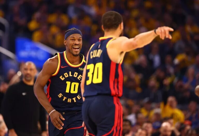Golden State Warriors forward Jimmy Butler III (10) celebrates towards guard Stephen Curry