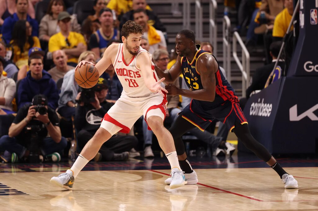 Houston Rockets center Alperen Sengun (28) controls the ball against Golden State Warriors forward Draymond Green