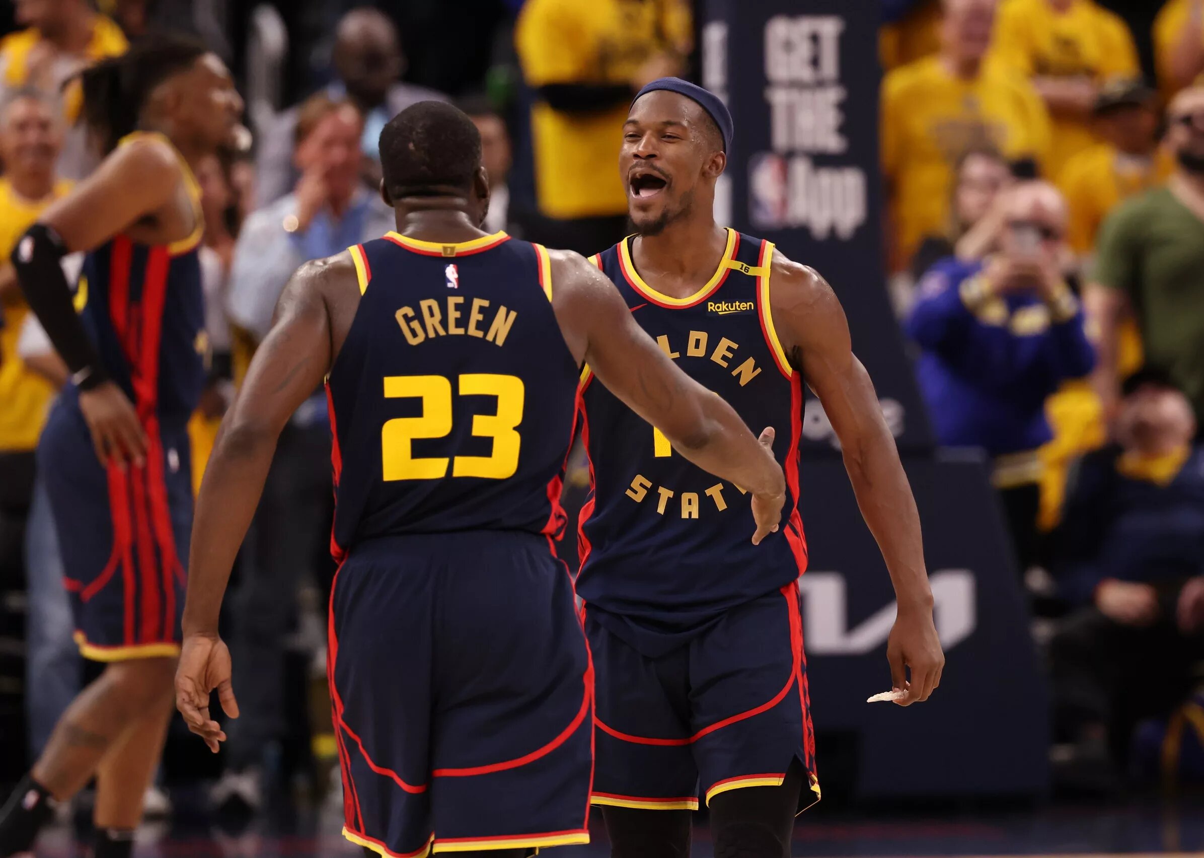 Golden State Warriors forward Draymond Green (23) celebrates with forward Jimmy Butler III (10) 