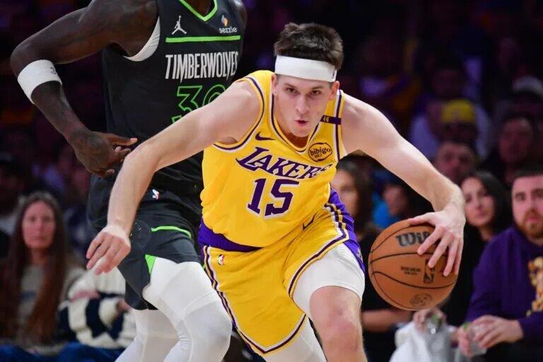 Los Angeles, California, USA; Los Angeles Lakers guard Austin Reaves (15) moves the ball ahead of Minnesota Timberwolves forward Julius Randle (30) during the first half in game five of first round for the 2025 NBA Playoffs at Crypto.com Arena.