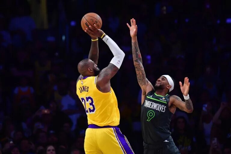 Apr 30, 2025; Los Angeles, California, USA; Los Angeles Lakers forward LeBron James (23) shoots against Minnesota Timberwolves guard Nickeil Alexander-Walker (9) during the second half in game five of first round for the 2025 NBA Playoffs at Crypto.com Arena. Mandatory Credit: Gary A. Vasquez-Imagn Images