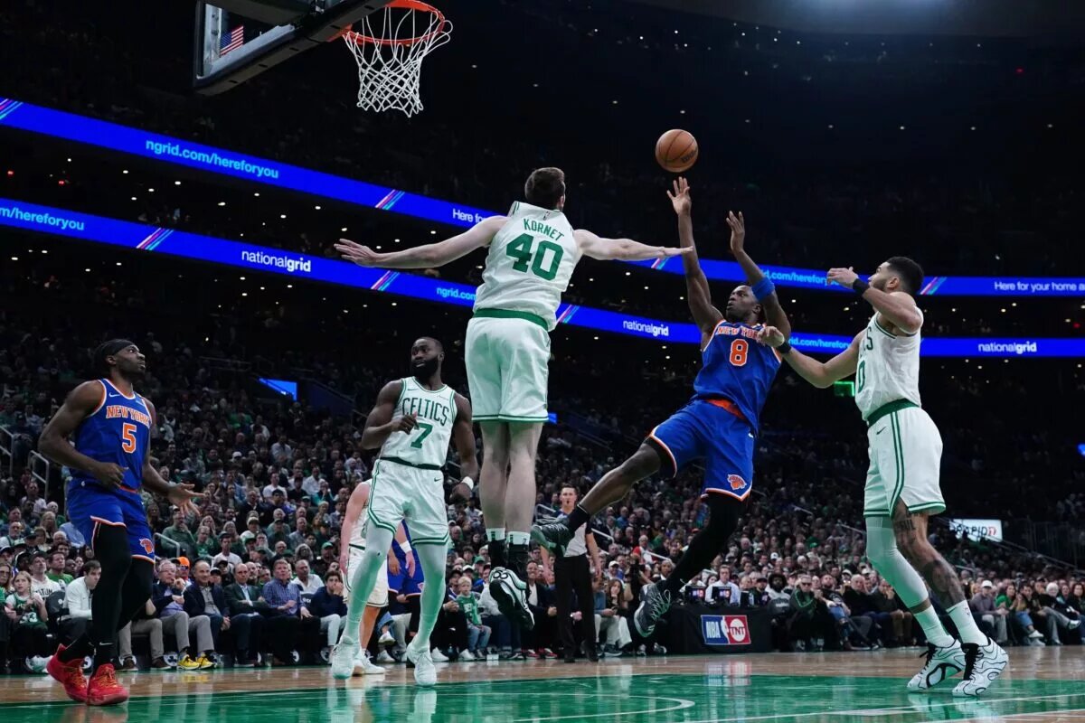 New York Knicks forward OG Anunoby (8) shoots the ball against Boston Celtics center Luke Kornet (40) in the third quarter during game one of the second round for the 2025 NBA Playoffs at TD Garden.