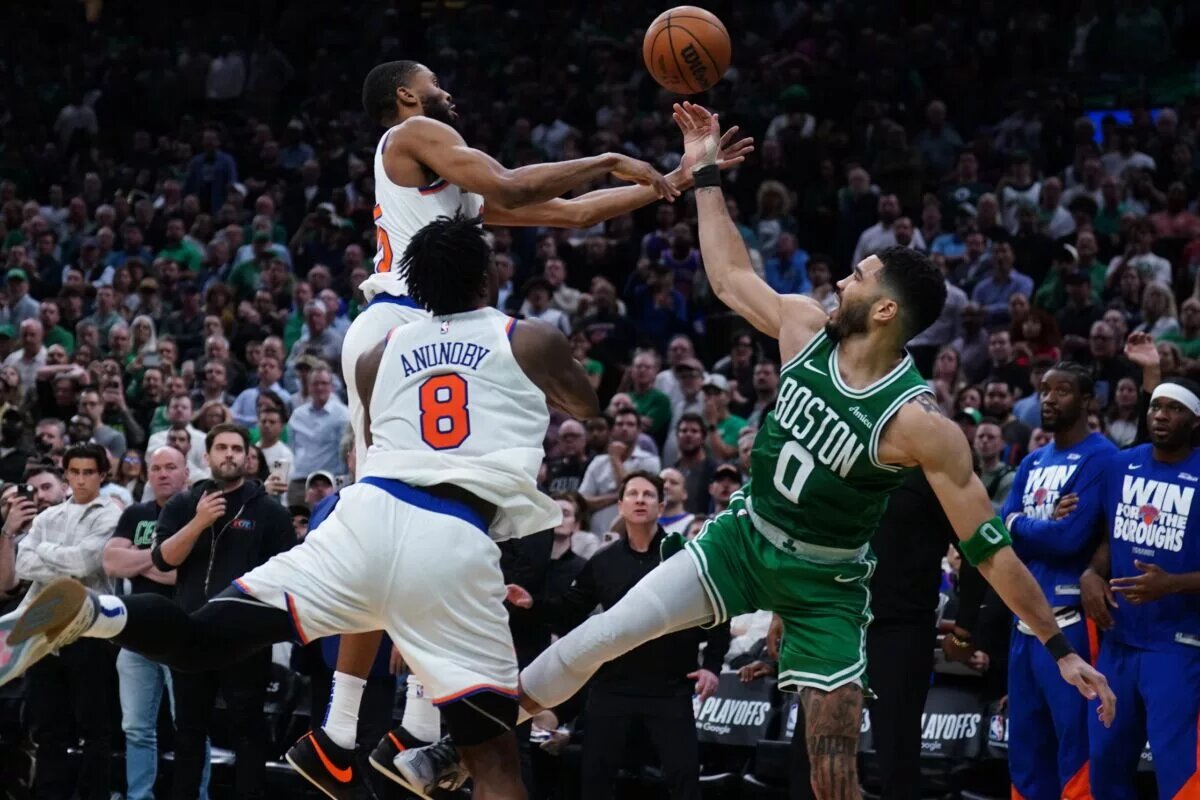 May 7, 2025; Boston, Massachusetts, USA; New York Knicks forward Mikal Bridges (25) defends against Boston Celtics forward Jayson Tatum (0) in the last seconds of the fourth quarter during game two of the second round for the 2025 NBA Playoffs at TD Garden. Mandatory Credit: David Butler II-Imagn Images