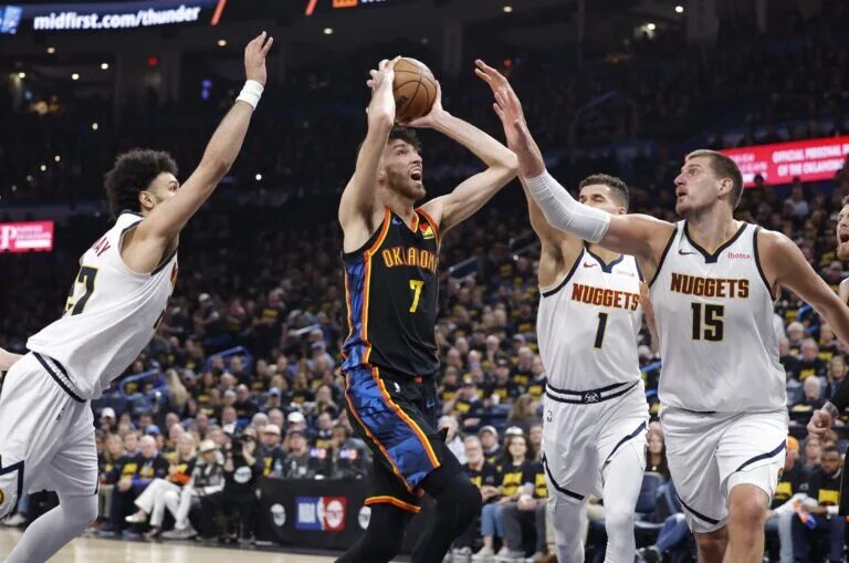 May 7, 2025; Oklahoma City, Oklahoma, USA;Oklahoma City Thunder forward Chet Holmgren (7) drives to the basket between Denver Nuggets guard Jamal Murray (27), forward Michael Porter Jr. (1) and center Nikola Jokic (15) in the second half during game two of the second round for the 2025 NBA Playoffs at Paycom Center. Mandatory Credit: Alonzo Adams-Imagn Images