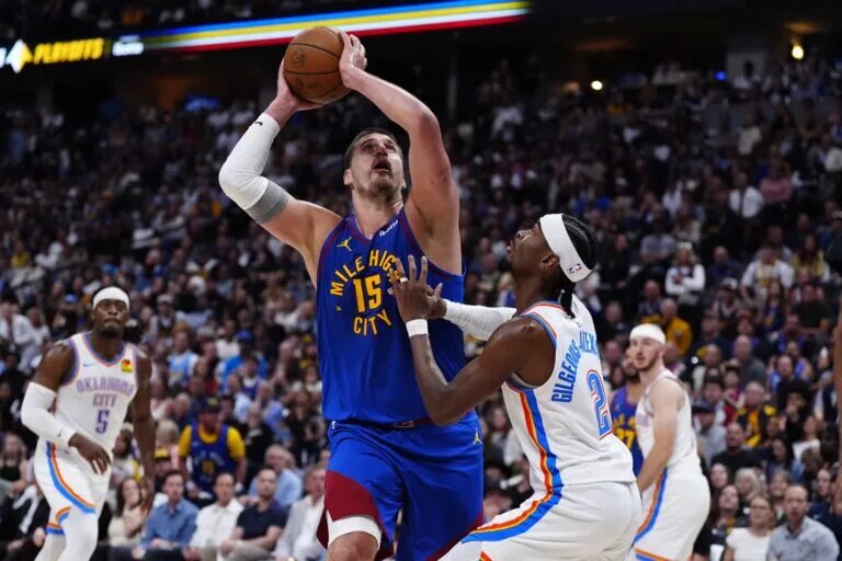 May 9, 2025; Denver, Colorado, USA; Oklahoma City Thunder guard Shai Gilgeous-Alexander (2) defends on Denver Nuggets center Nikola Jokic (15) in the second half during game three of the second round for the 2025 NBA Playoffs at Ball Arena. Mandatory Credit: Ron Chenoy-Imagn Images
