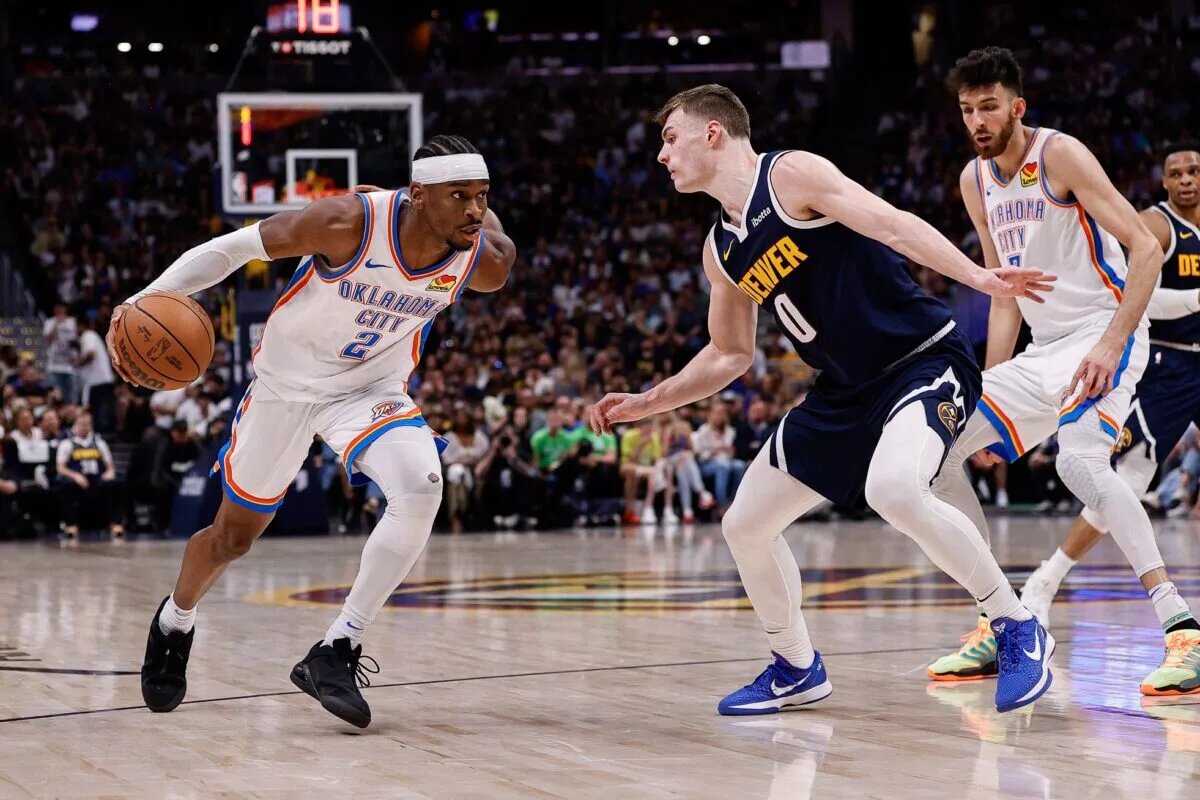 May 11, 2025; Denver, Colorado, USA; Oklahoma City Thunder guard Shai Gilgeous-Alexander (2) controls the ball as Denver Nuggets guard Christian Braun (0) guards in the second quarter during game four of the second round of the 2025 NBA Playoffs at Ball Arena. Mandatory Credit: Isaiah J. Downing-Imagn Images