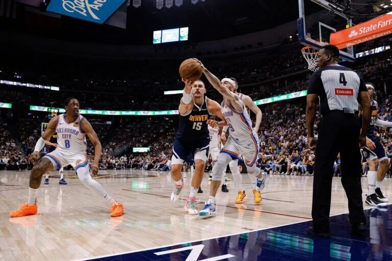 May 11, 2025; Denver, Colorado, USA; Denver Nuggets center Nikola Jokic (15) and Oklahoma City Thunder guard Alex Caruso (9) battle for a loose ball as forward Jalen Williams (8) and referee Sean Wright (4) look on in the fourth quarter during game four of the second round of the 2025 NBA Playoffs at Ball Arena. Mandatory Credit: Isaiah J. Downing-Imagn Images