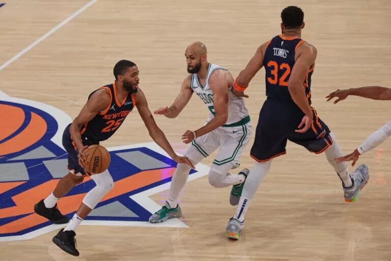 May 12, 2025; New York, New York, USA; New York Knicks forward Mikal Bridges (25) dribbles as Boston Celtics guard Derrick White (9) fights through a screen by New York Knicks center Karl-Anthony Towns (32) in the first half during game four of the second round for the 2025 NBA Playoffs at Madison Square Garden. Mandatory Credit: Vincent Carchietta-Imagn Images