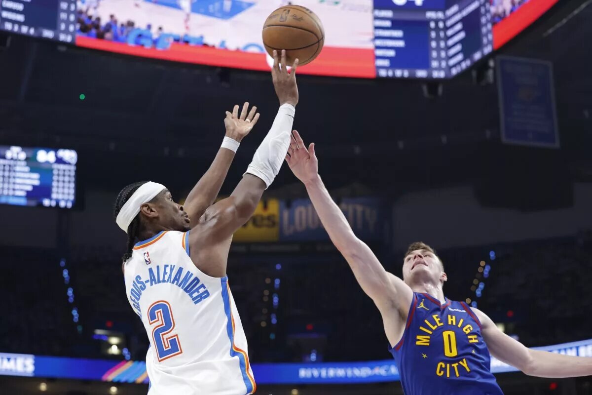 May 13, 2025; Oklahoma City, Oklahoma, USA; Oklahoma City Thunder guard Shai Gilgeous-Alexander (2) shoots as Denver Nuggets guard Christian Braun (0) defends during the second half of game five of the second round for the 2025 NBA Playoffs at Paycom Center. Mandatory Credit: Alonzo Adams-Imagn Images