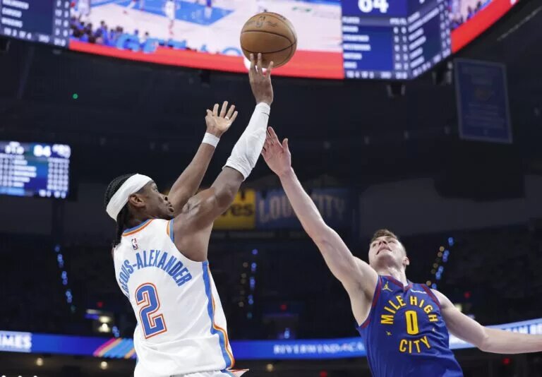 May 13, 2025; Oklahoma City, Oklahoma, USA; Oklahoma City Thunder guard Shai Gilgeous-Alexander (2) shoots as Denver Nuggets guard Christian Braun (0) defends during the second half of game five of the second round for the 2025 NBA Playoffs at Paycom Center. Mandatory Credit: Alonzo Adams-Imagn Images