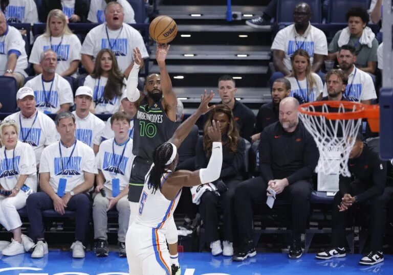 May 20, 2025; Oklahoma City, Oklahoma, USA; Minnesota Timberwolves guard Mike Conley (10) shoots against Oklahoma City Thunder guard Luguentz Dort (5) in the third quarter during game one of the western conference finals for the 2025 NBA Playoffs at Paycom Center. Mandatory Credit: Alonzo Adams-Imagn Images