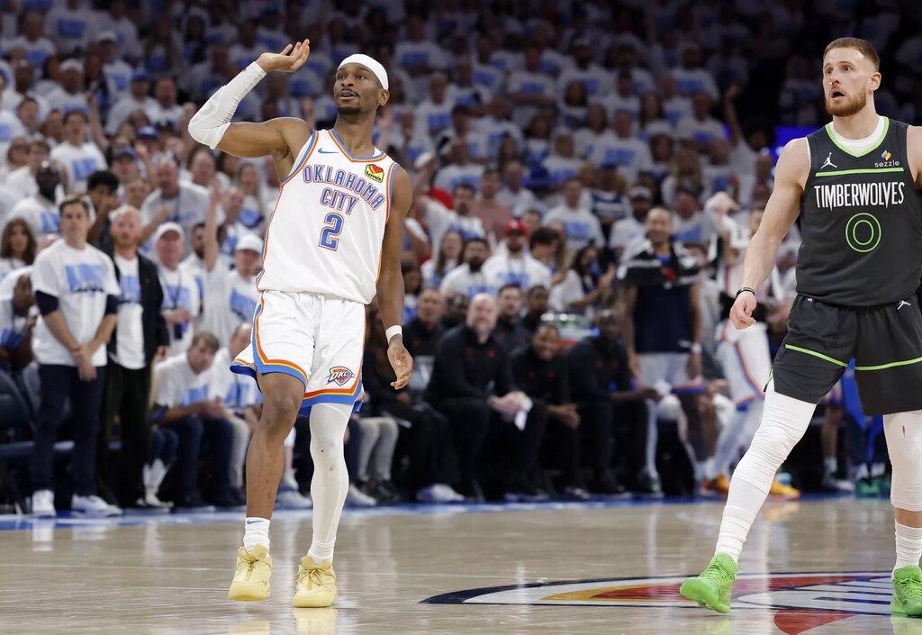 May 20, 2025; Oklahoma City, Oklahoma, USA; Oklahoma City Thunder guard Shai Gilgeous-Alexander (2) watches a shot against Minnesota Timberwolves guard Donte DiVincenzo (0) in the fourth quarter during game one of the western conference finals for the 2025 NBA Playoffs at Paycom Center. Mandatory Credit: Alonzo Adams-Imagn Images