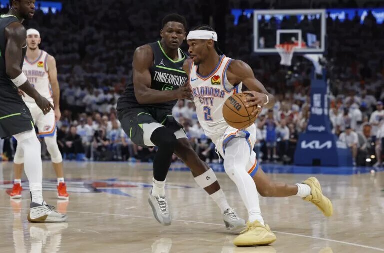 May 20, 2025; Oklahoma City, Oklahoma, USA; Oklahoma City Thunder guard Shai Gilgeous-Alexander (2) drives against Minnesota Timberwolves guard Anthony Edwards (5) in the fourth quarter during game one of the western conference finals for the 2025 NBA Playoffs at Paycom Center. Mandatory Credit: Alonzo Adams-Imagn Images