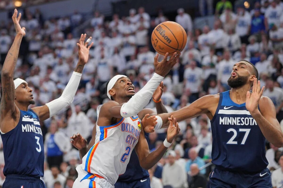 May 24, 2025; Minneapolis, Minnesota, USA; Oklahoma City Thunder guard Shai Gilgeous-Alexander (2) shoots the ball over Minnesota Timberwolves center Rudy Gobert (27) during the first half in game three of the western conference finals for the 2025 NBA Playoffs at Target Center. Mandatory Credit: Brad Rempel-Imagn Images