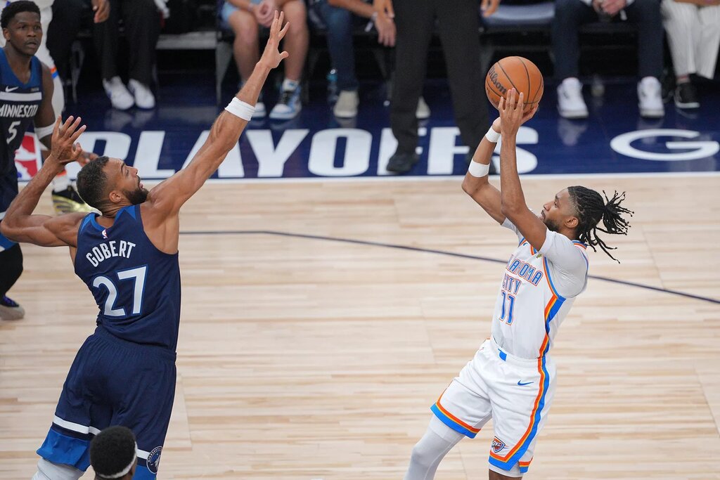 May 24, 2025; Minneapolis, Minnesota, USA; Oklahoma City Thunder guard Isaiah Joe (11) shoots the ball over Minnesota Timberwolves center Rudy Gobert (27) during the second half in game three of the western conference finals for the 2025 NBA Playoffs at Target Center. Mandatory Credit: Brad Rempel-Imagn Images