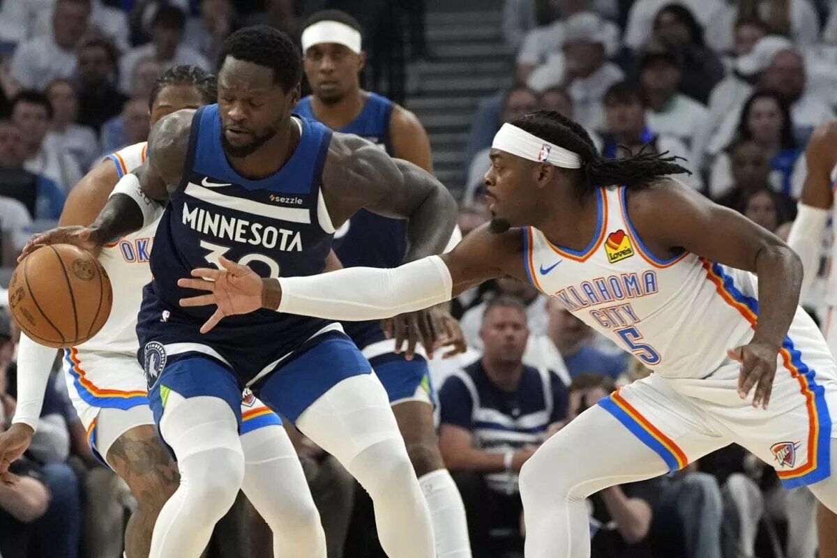 May 26, 2025; Minneapolis, Minnesota, USA; Minnesota Timberwolves forward Julius Randle (30) dribbles the ball against Oklahoma City Thunder guard Luguentz Dort (5) in the first half in game four of the western conference finals for the 2025 NBA Playoffs at Target Center. Mandatory Credit: Bruce Kluckhohn-Imagn Images