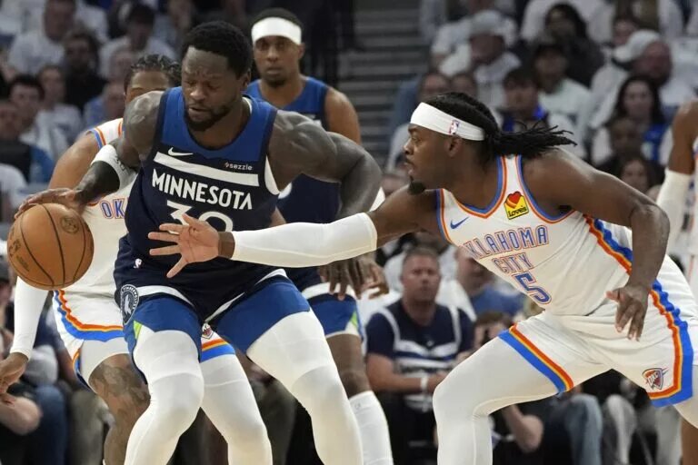 May 26, 2025; Minneapolis, Minnesota, USA; Minnesota Timberwolves forward Julius Randle (30) dribbles the ball against Oklahoma City Thunder guard Luguentz Dort (5) in the first half in game four of the western conference finals for the 2025 NBA Playoffs at Target Center. Mandatory Credit: Bruce Kluckhohn-Imagn Images