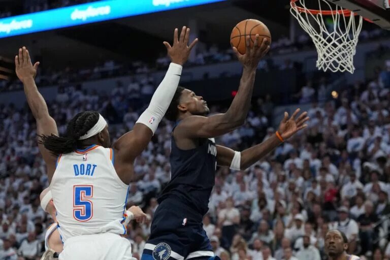 May 26, 2025; Minneapolis, Minnesota, USA; Minnesota Timberwolves guard Anthony Edwards (5) shoots the ball against Oklahoma City Thunder guard Luguentz Dort (5) in the first half during game four of the western conference finals for the 2025 NBA Playoffs at Target Center. Mandatory Credit: Jesse Johnson-Imagn Images