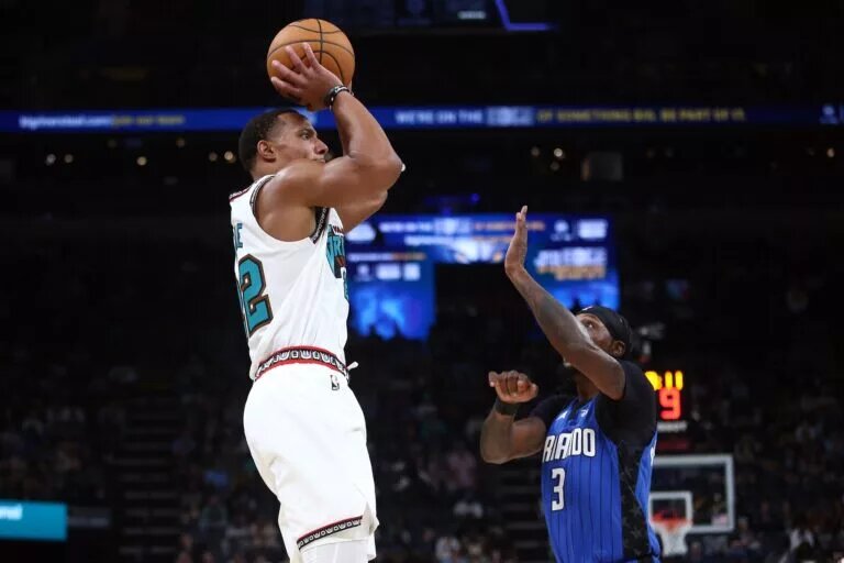 Memphis Grizzlies guard Desmond Bane (22) shoots as Orlando Magic guard Kentavious Caldwell-Pope (3) defends
