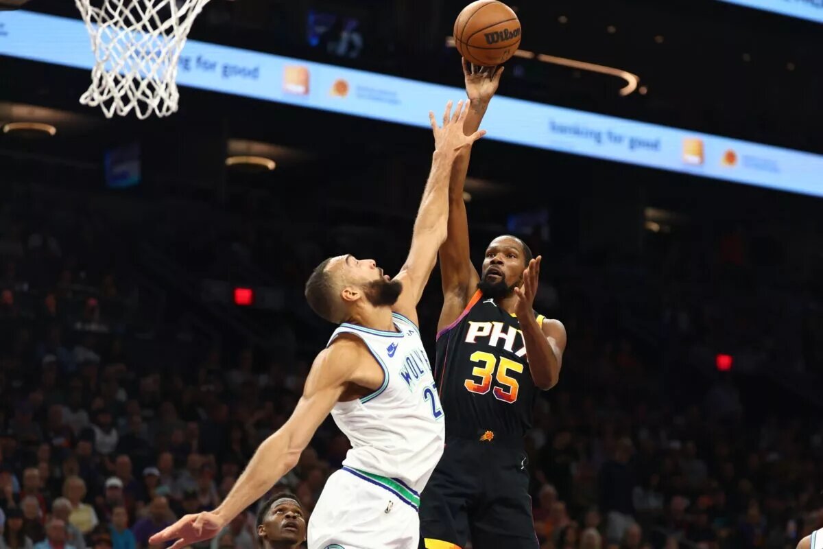 Phoenix Suns forward Kevin Durant attempts to shoot over Minnesota Timberwolves center Rudy Gobert