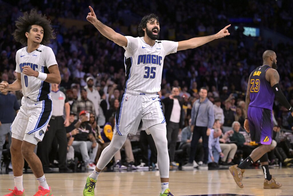 Nov 21, 2024; Los Angeles, California, USA; Los Angeles Lakers forward LeBron James (23) walks off the court as Orlando Magic center Goga Bitadze (35) celebrates after a 119-118 win at Crypto.com Arena. Mandatory Credit: Jayne Kamin-Oncea-Imagn Images