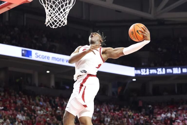Nov 22, 2024; Fayetteville, Arkansas, USA; Arkansas Razorbacks forward Adou Thiero (3) goes up for a dunk in the second half against the Little Rock Trojans at Bud Walton Arena. Arkansas won 79-67. Mandatory Credit: Nelson Chenault-Imagn Images