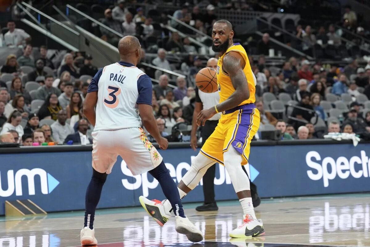 Nov 27, 2024; San Antonio, Texas, USA; Los Angeles Lakers forward LeBron James (23) controls the ball in front of San Antonio Spurs guard Chris Paul (3) in the second half at Frost Bank Center. Mandatory Credit: Daniel Dunn-Imagn Images
