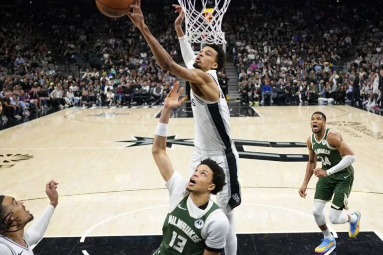 Jan 31, 2025; San Antonio, Texas, USA; San Antonio Spurs center Victor Wembanyama (1) blocks the shot attempt by Milwaukee Bucks guard Ryan Rollins (13) during the first half at Frost Bank Center. Mandatory Credit: Scott Wachter-Imagn Images
