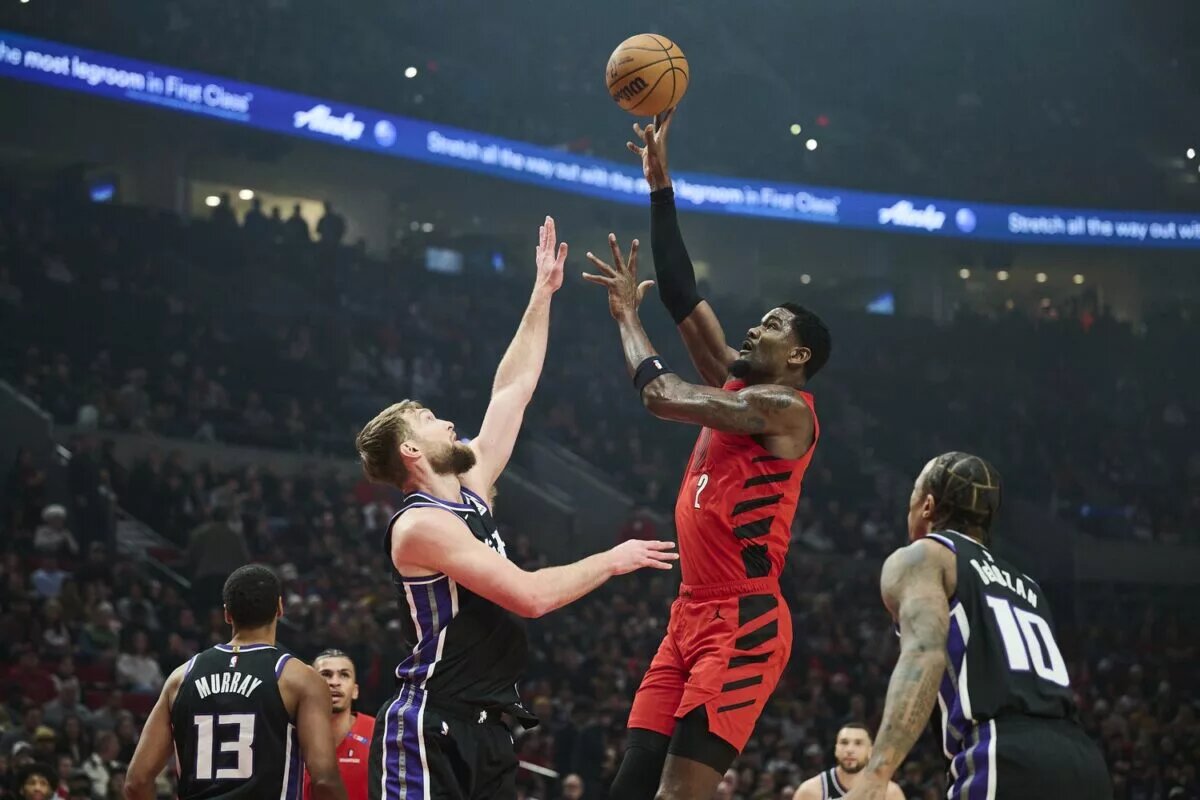Feb 6, 2025; Portland, Oregon, USA;Portland Trail Blazers center Deandre Ayton (2) shoots a jump shot the ball during the first half against Sacramento Kings forward Domantas Sabonis (11) at Moda Center. Mandatory Credit: Troy Wayrynen-Imagn Images