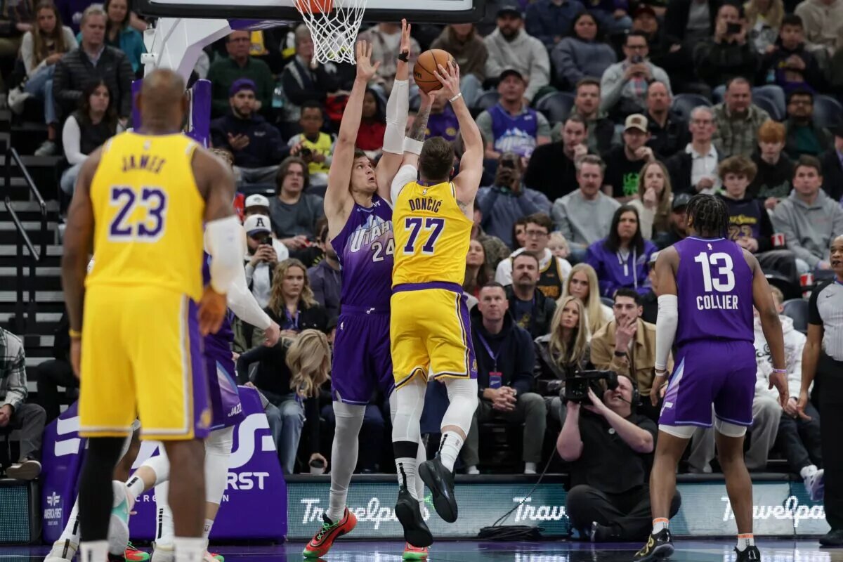 Feb 12, 2025; Salt Lake City, Utah, USA; Los Angeles Lakers guard Luka Doncic (77) shoots against Utah Jazz center Walker Kessler (24) during the second half at Delta Center. Mandatory Credit: Chris Nicoll-Imagn Images