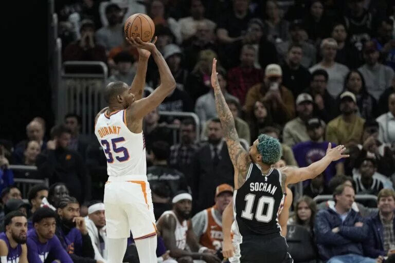 Feb 20, 2025; Austin, Texas, USA; Phoenix Suns forward Kevin Durant (35) shoots over San Antonio Spurs forward Jeremy Sochan (10) during the second half at Moody Center. Mandatory Credit: Scott Wachter-Imagn Images