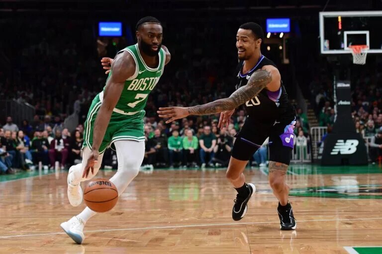 Boston Celtics wing Jaylen Brown blows past Utah Jazz big man John Collins