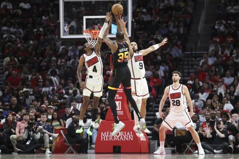Phoenix Suns forward Kevin Durant shoots over Houston Rockets rising stars Jalen Green and Alperen Sengun