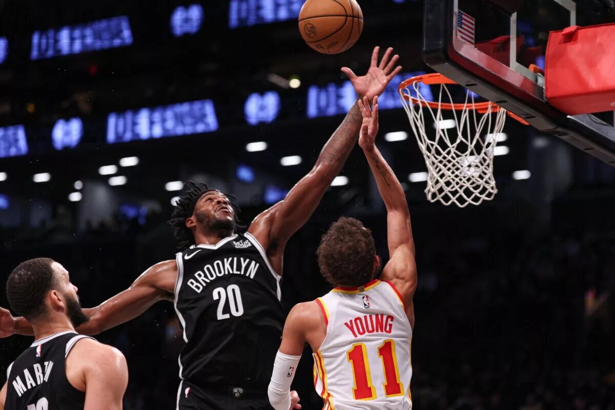 Mar 16, 2025; Brooklyn, New York, USA; Brooklyn Nets center Day'Ron Sharpe (20) blocks a shot by Atlanta Hawks guard Trae Young (11) during the first half at Barclays Center. Mandatory Credit: Vincent Carchietta-Imagn Images