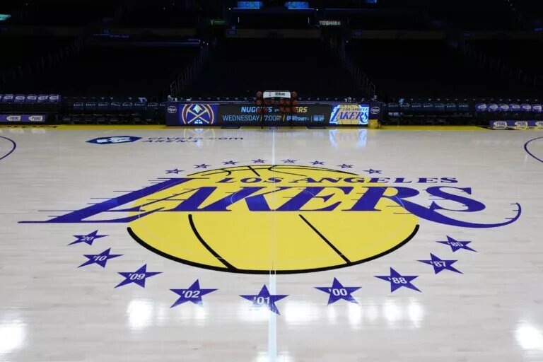 Mar 17, 2025; Los Angeles, California, USA; The Los Angeles Lakers logo at midcourt at Crypto.com Arena. Mandatory Credit: Kirby Lee-Imagn Images