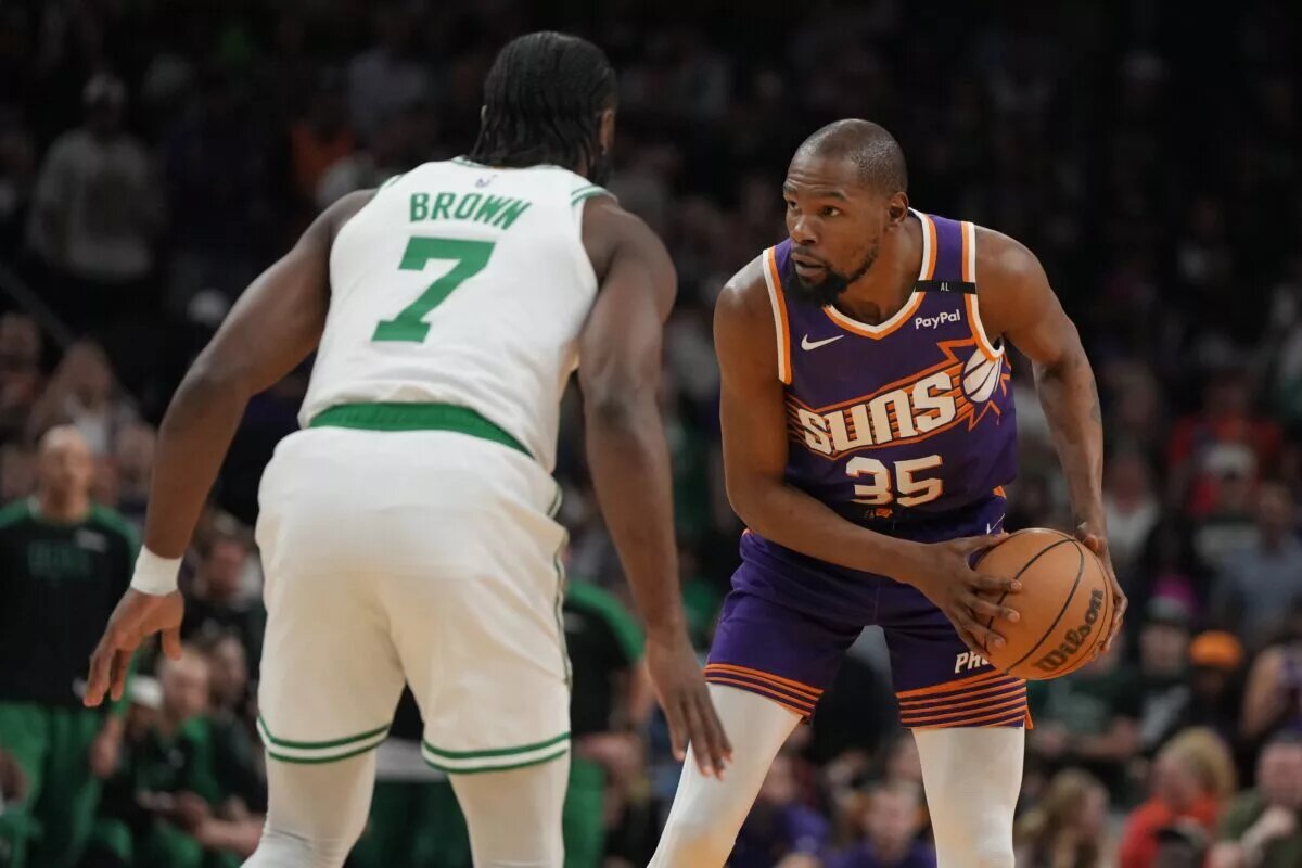 Mar 26, 2025; Phoenix, Arizona, USA; Phoenix Suns forward Kevin Durant (35) shields the ball from Boston Celtics guard Jaylen Brown (7) during the first half at Footprint Center. Mandatory Credit: Rick Scuteri-Imagn Images