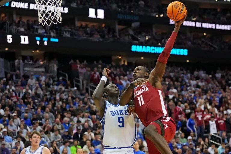 Mar 29, 2025; Newark, NJ, USA; Alabama Crimson Tide center Clifford Omoruyi (11) shoots the ball against Duke Blue Devils center Khaman Maluach (9) during the first half in the East Regional final of the 2025 NCAA tournament at Prudential Center. Mandatory Credit: Robert Deutsch-Imagn Images