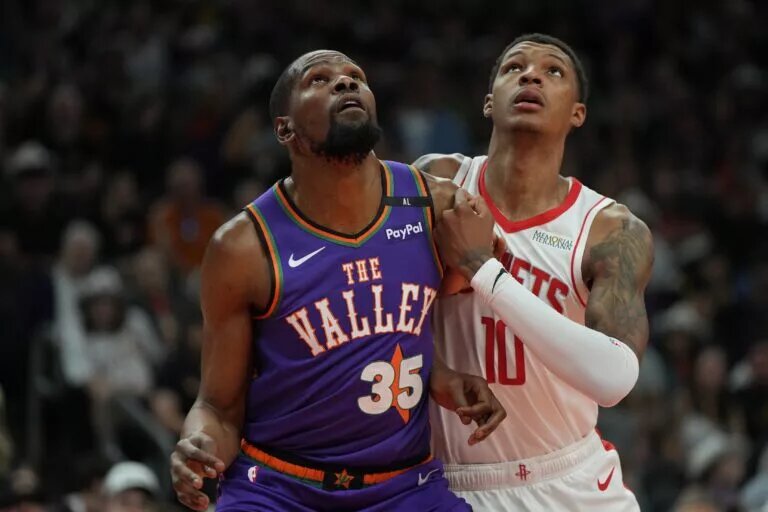 Mar 30, 2025; Phoenix, Arizona, USA; Phoenix Suns forward Kevin Durant (35) and Houston Rockets forward Jabari Smith Jr. (10) fight for position in the first half at Footprint Center. Mandatory Credit: Rick Scuteri-Imagn Images